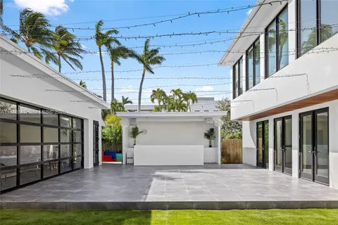 a view of a house with a patio and a yard