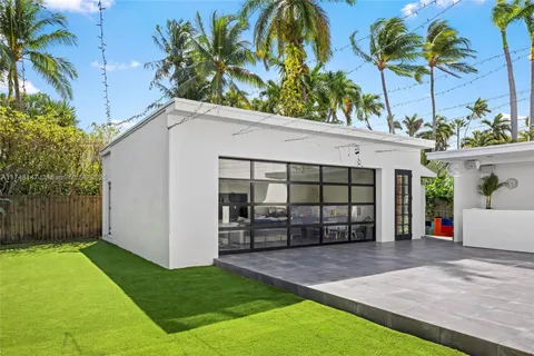 a front view of a house with a garden and yard