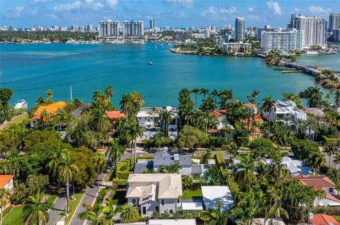 an aerial view of a houses with a lake view