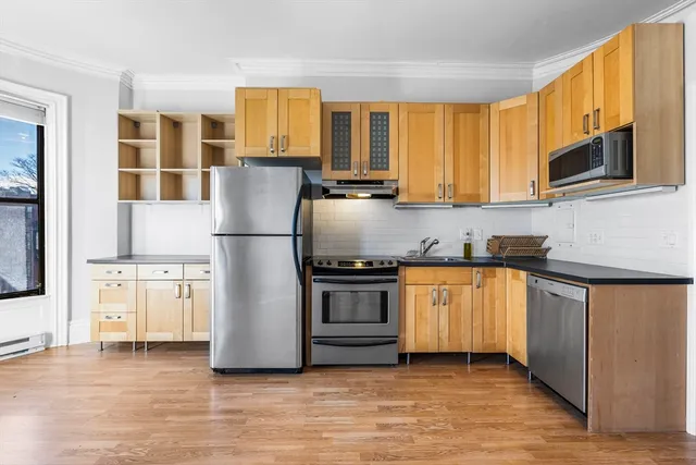 a kitchen with stainless steel appliances granite countertop a refrigerator and a stove top oven