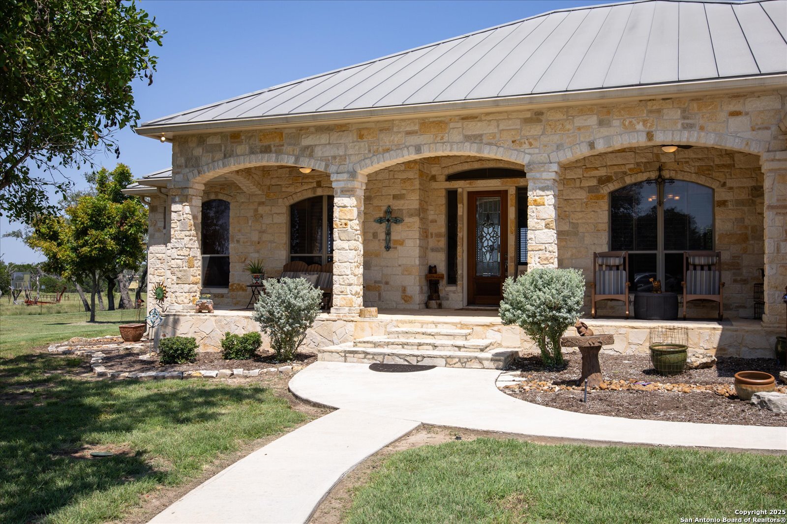 34 Cravey Road Boerne, TX 78006 - Photo 5 of 69 a view of a house with potted plants and a table and chairs
