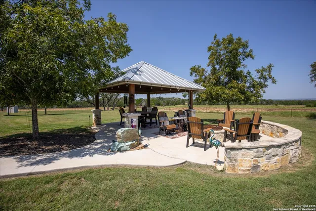 a living room with furniture a fireplace and a chandelier