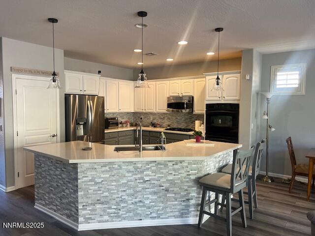 1220 Cliff Park Way Reno, NV 89523 - Photo 4 of 17 a kitchen with stainless steel appliances kitchen island granite countertop a refrigerator a stove a sink a dining table and chairs with wooden floor