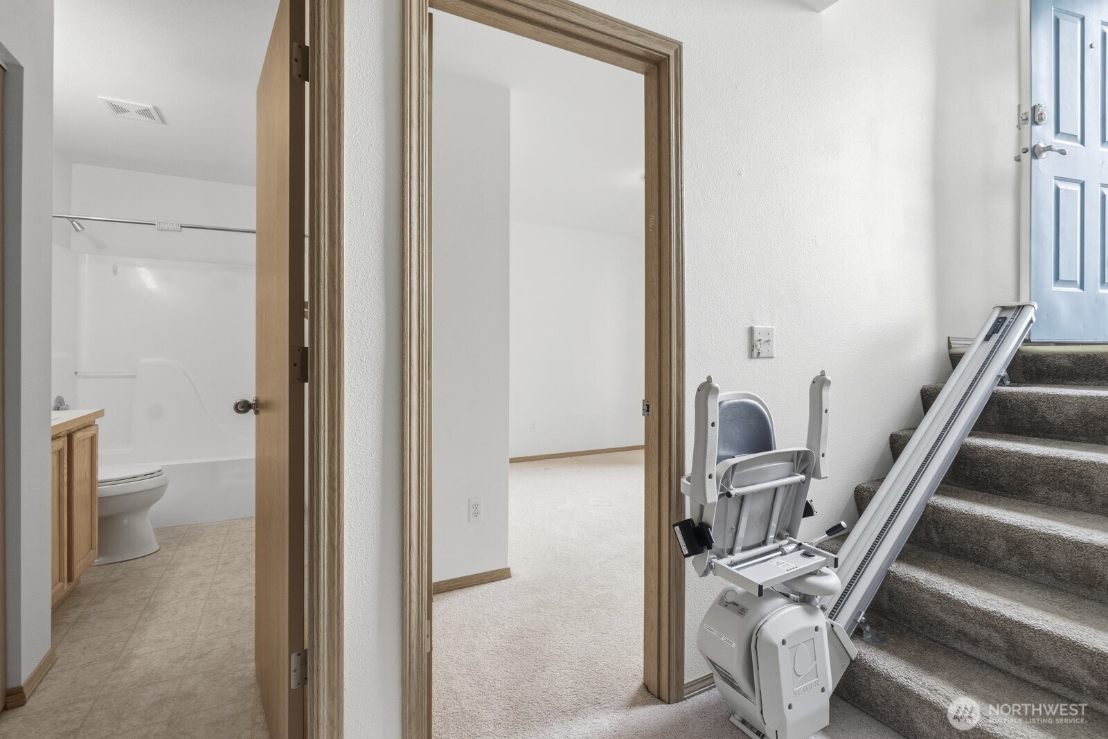 14905 Prairie Vista Loop Southeast Yelm, WA 98597 - Photo 28 of 40 a view of a hallway with wooden floor and a bathroom