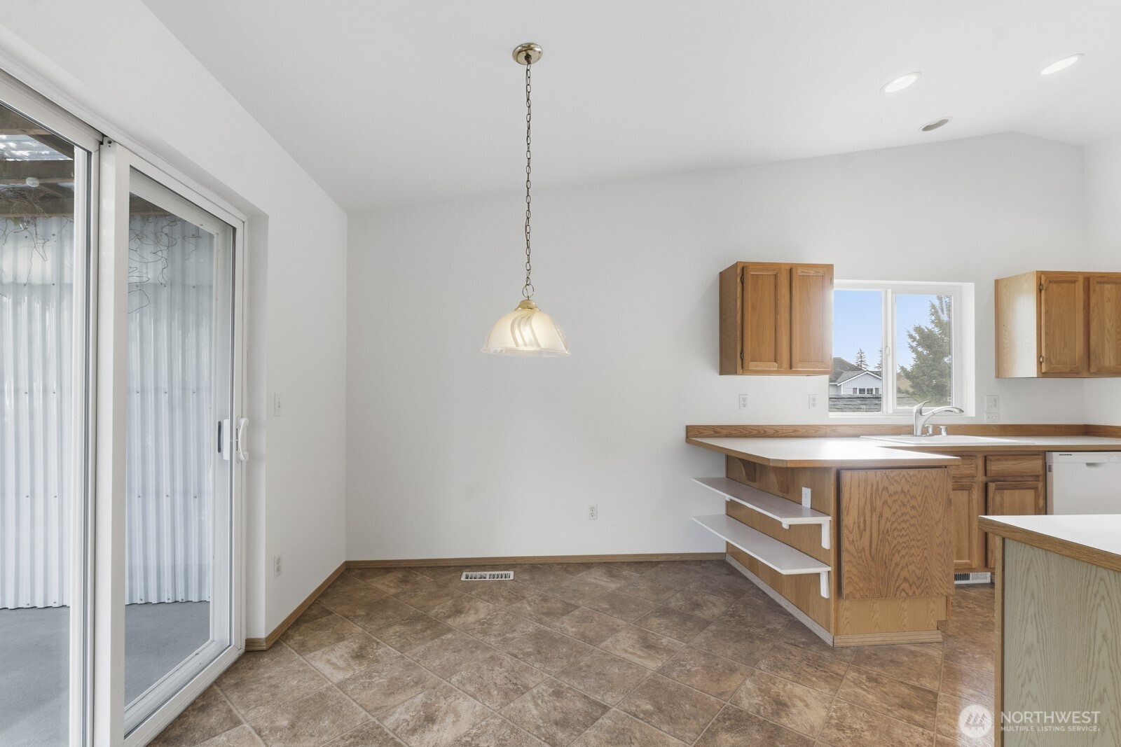 14905 Prairie Vista Loop Southeast Yelm, WA 98597 - Photo 7 of 40 a view of a kitchen with kitchen island a sink stainless steel appliances and cabinets