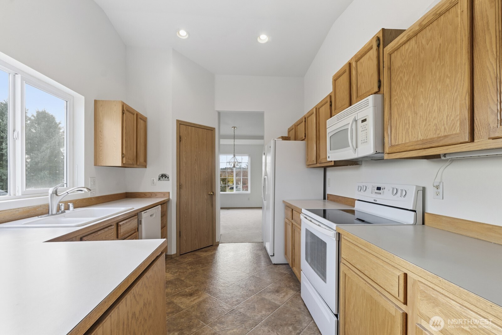 14905 Prairie Vista Loop Southeast Yelm, WA 98597 - Photo 8 of 40 a kitchen with stainless steel appliances granite countertop a sink and a stove top oven