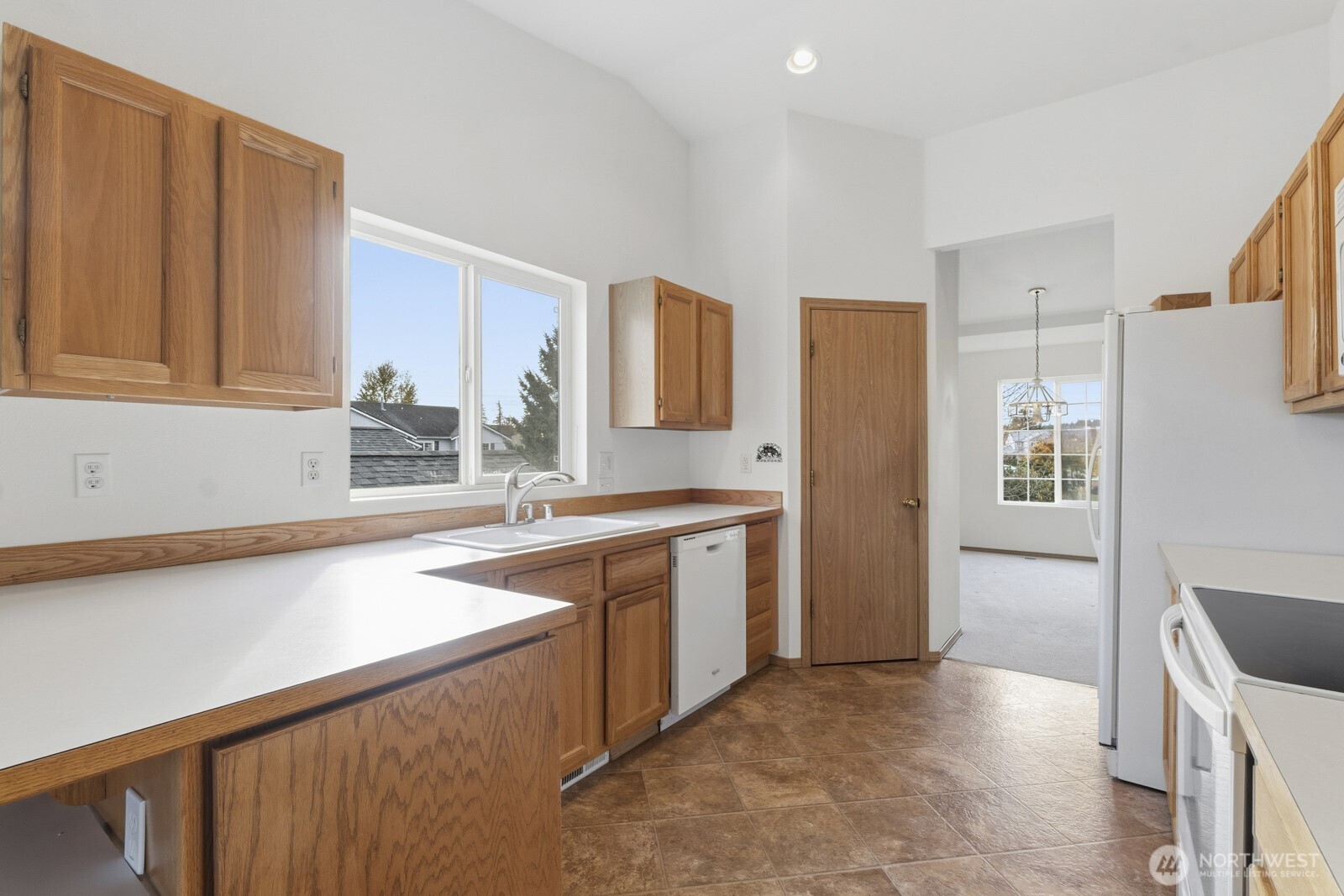 14905 Prairie Vista Loop Southeast Yelm, WA 98597 - Photo 10 of 40 a kitchen with a sink a stove cabinets and a wooden floor