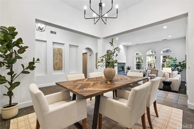 a kitchen with stainless steel appliances granite countertop a stove a sink a microwave a refrigerator and cabinets