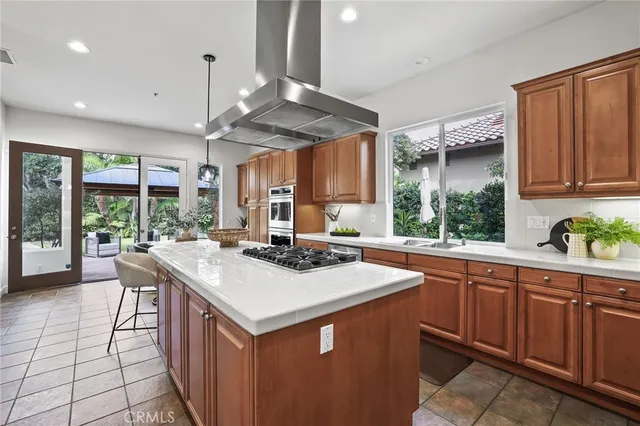 a kitchen with a stove a refrigerator and wooden floor