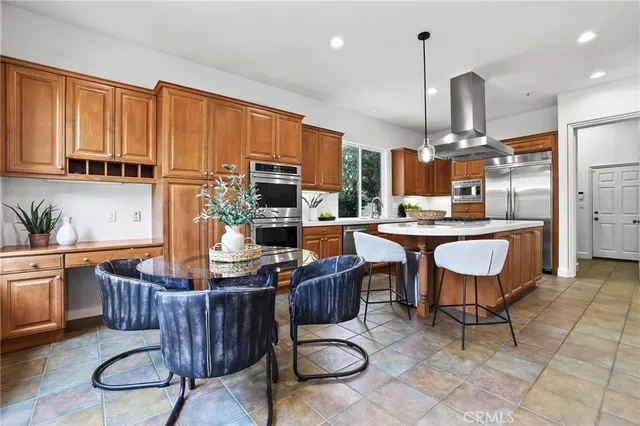a kitchen with a table and chairs