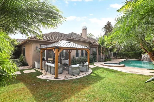 a view of a house with backyard porch and sitting area