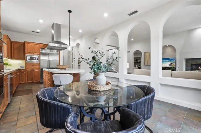 a kitchen with white cabinets and sink