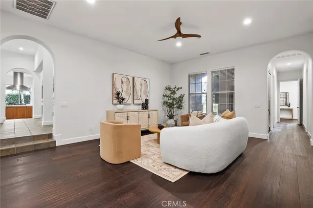 a living room with furniture and a potted plant