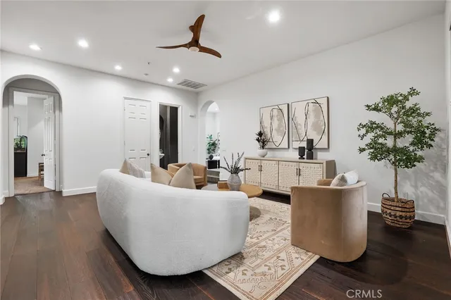 a living room with furniture and a wooden floor