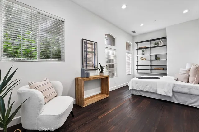 a bedroom with bed and wooden floor