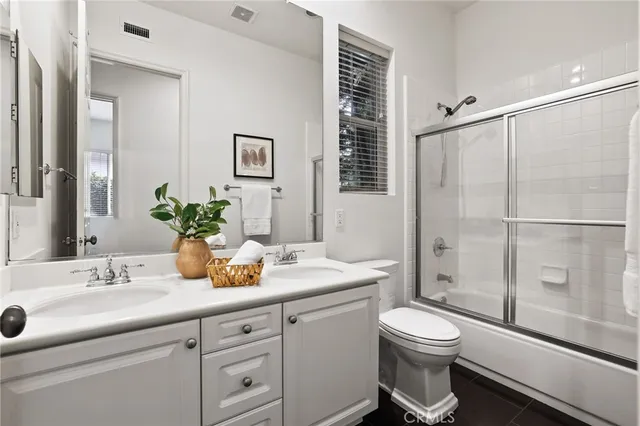 a spacious bedroom with a bed and a large window