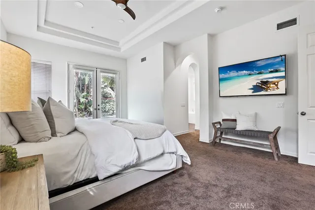 a bedroom with a bed and painting on the wall