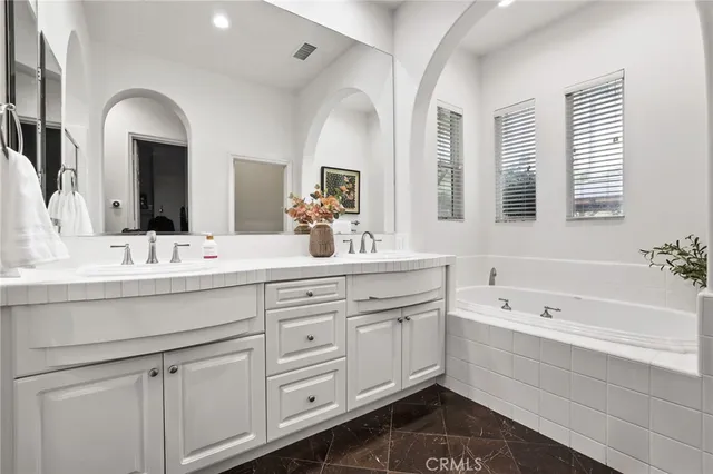 a bathroom with a double vanity sink mirror and shower