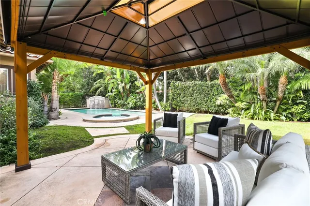 a view of backyard with swimming pool and porch