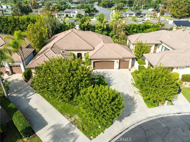 an aerial view of multiple houses with a yard