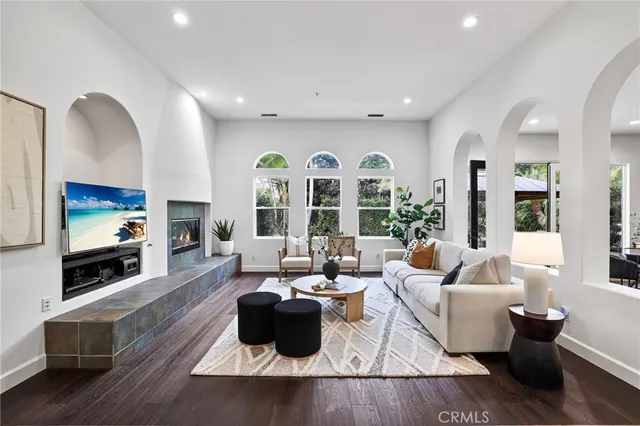 a living room with furniture a fireplace and a flat screen tv
