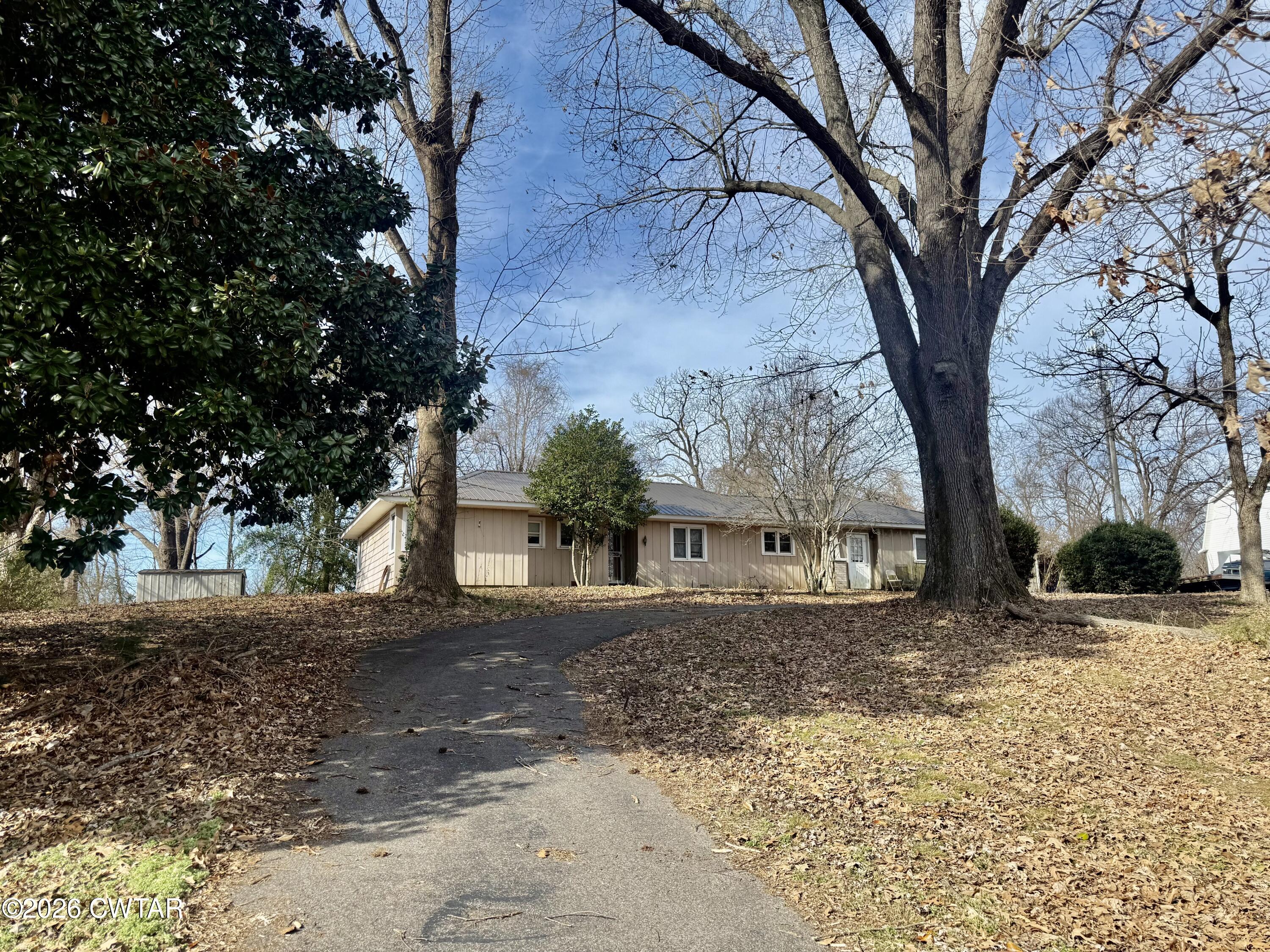 519 South Chestnut Street Troy, TN 38260 - Photo 2 of 16 a view of a yard covered with snow in the yard