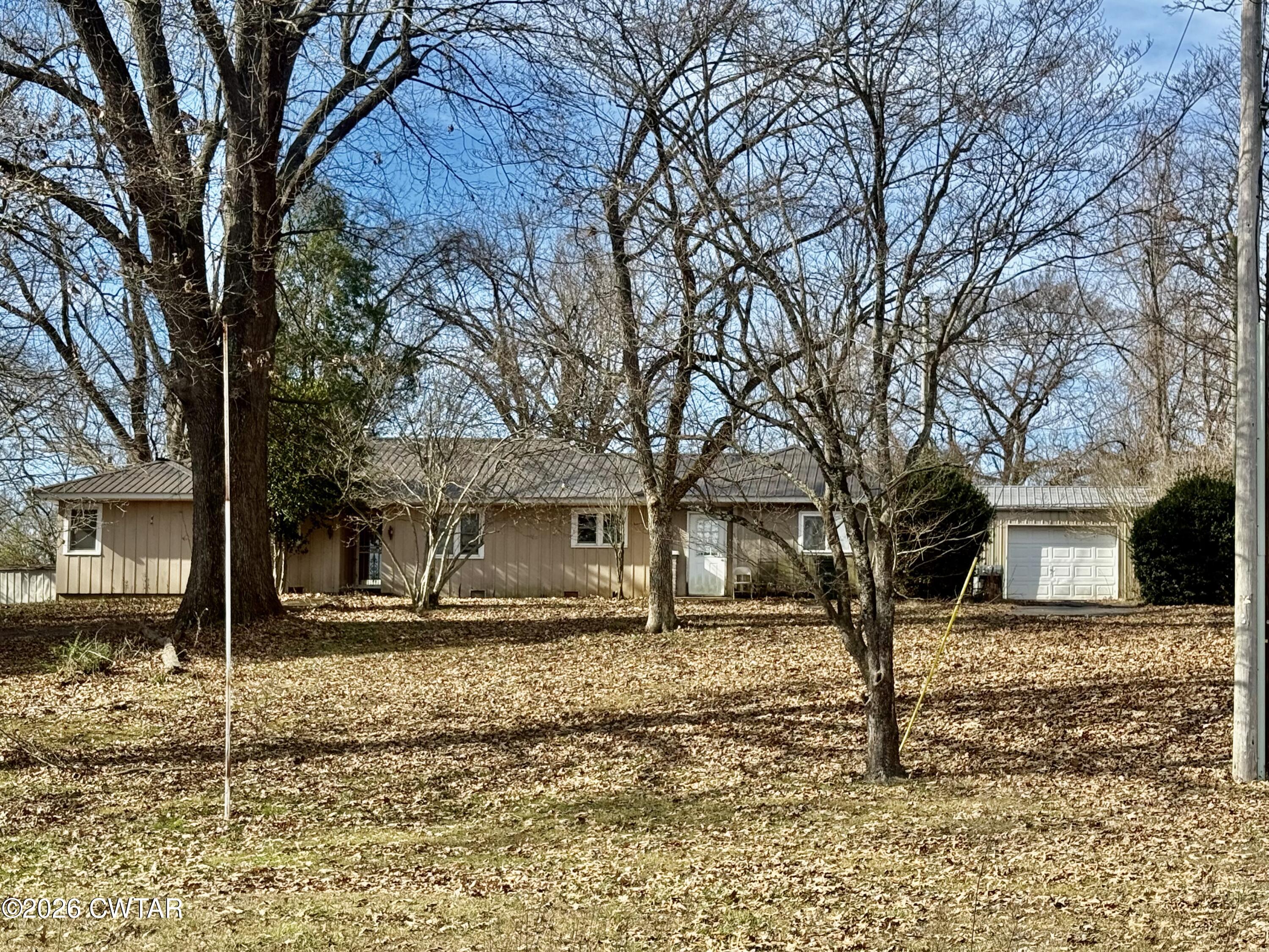 519 South Chestnut Street Troy, TN 38260 - Photo 3 of 16 a front view of a house with a yard