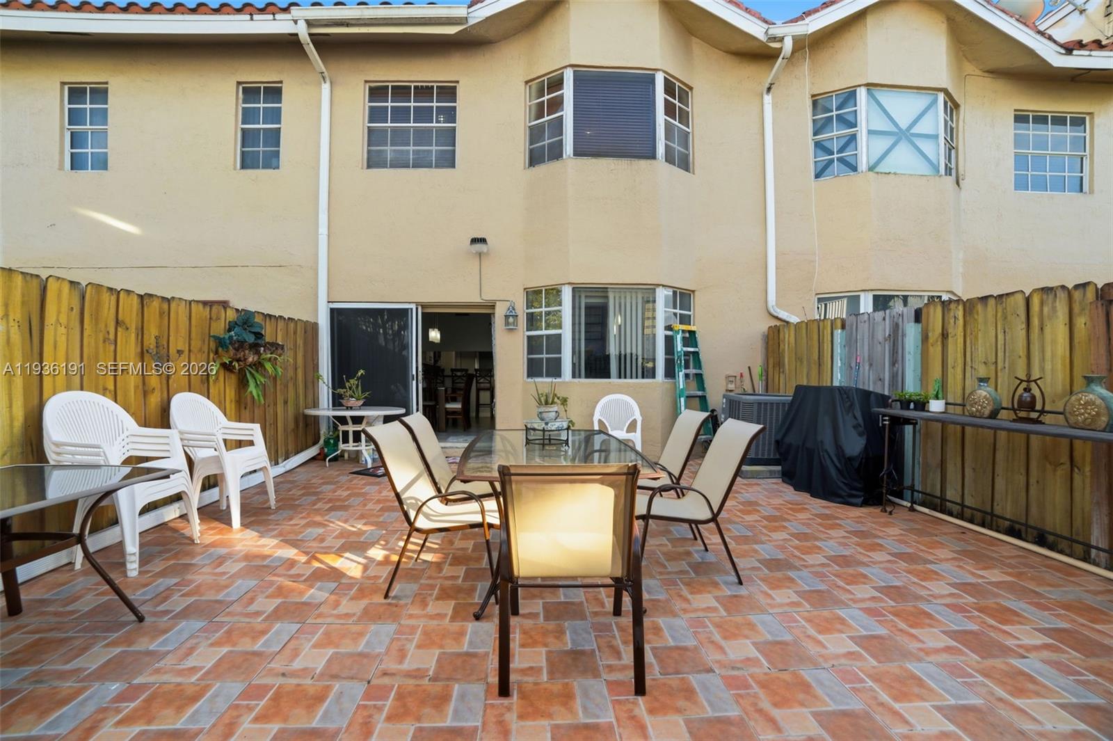 6400 Southwest 138th Court, Unit 203 Miami, FL 33183 - Photo 22 of 22 a view of a patio with a dining table and chairs
