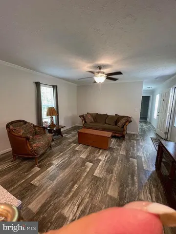a living room with a couch and chandelier