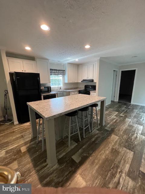 535 Parrish Lane Colonial Beach, VA 22443 - Photo 6 of 18 a kitchen with stainless steel appliances a kitchen island hardwood floor sink stove dining table and chairs