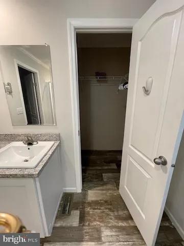 a bathroom with a sink a mirror and a shower