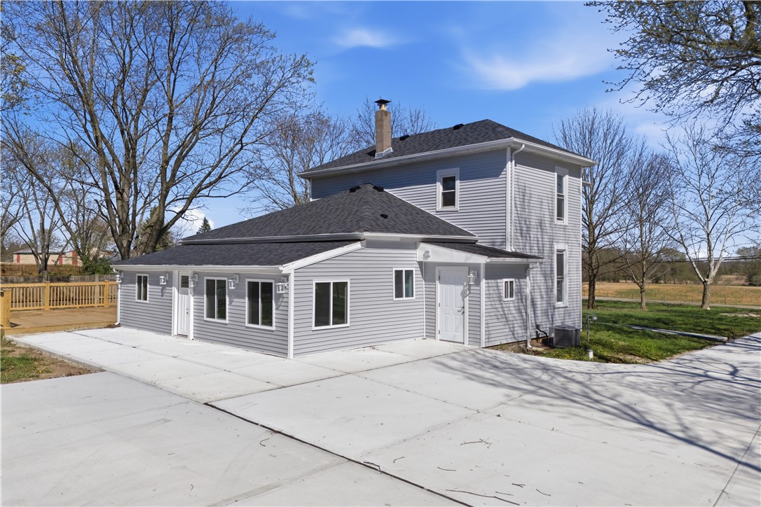 3190 Rebert Pike Springfield, OH 45502 - Photo 4 of 48 This newly renovated home features a classic siding exterior and an expansive concrete driveway.