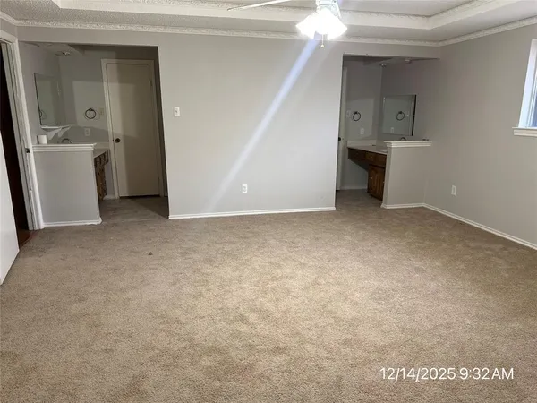 an empty room with closet and windows