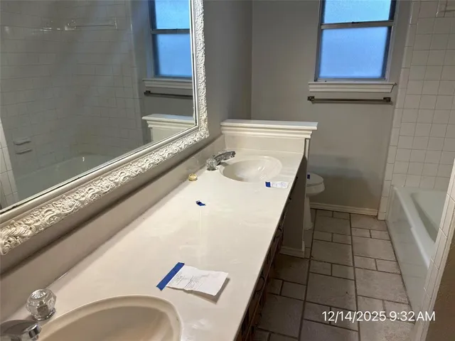 a bathroom with a tub a sink and a shower