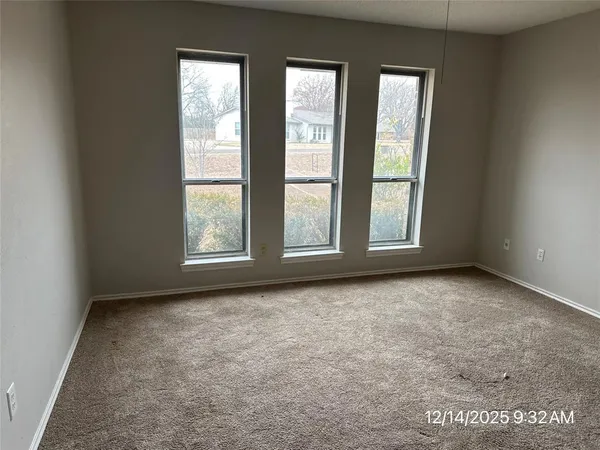 a view of an empty room with a cabinet