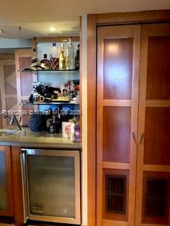 1688 West Avenue, Unit 405 Miami Beach, FL 33139 - Photo 6 of 23 a kitchen with stainless steel appliances granite countertop a refrigerator and a stove