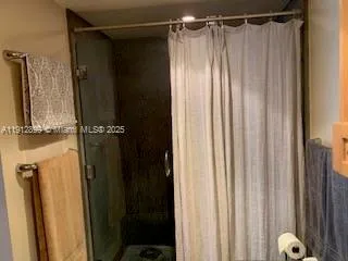 a view of a bathroom with a shower and a tub