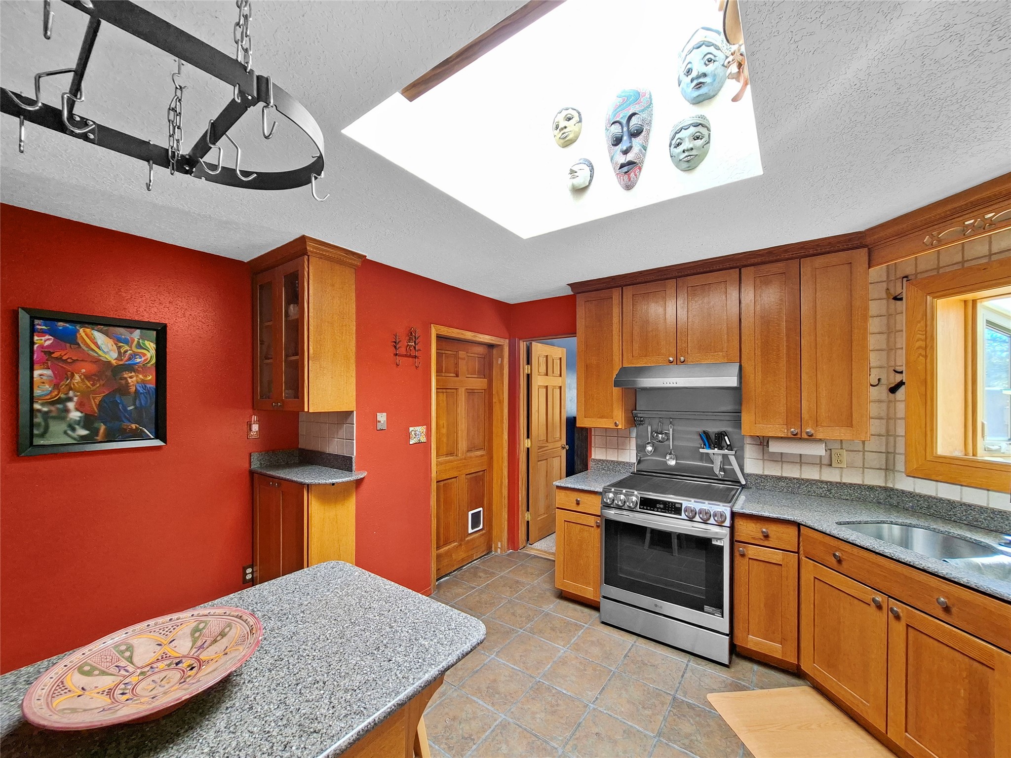 57 Verano Loop Santa Fe, NM 87508 - Photo 15 of 43 Kitchen with large skylight.