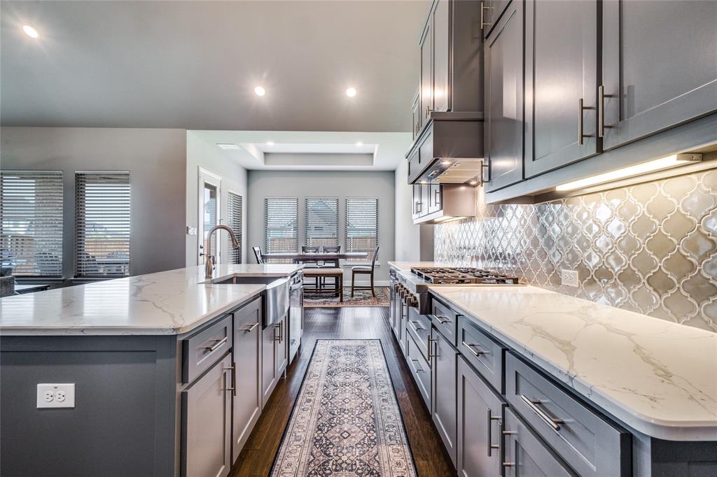 11112 Lacey Oak Ridge Flower Mound, TX 76226 - Photo 16 of 40 a kitchen with sink stove and cabinets