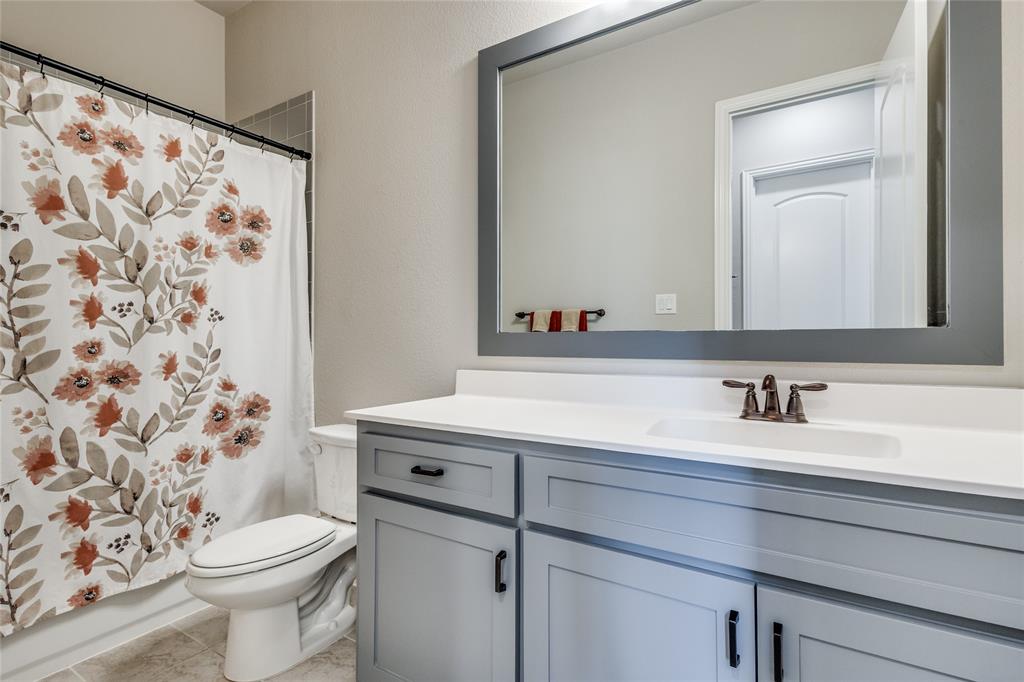 11112 Lacey Oak Ridge Flower Mound, TX 76226 - Photo 28 of 40 a bathroom with a sink and a toilet