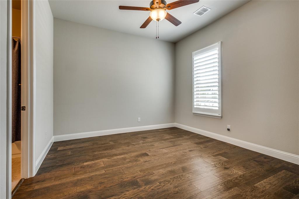11112 Lacey Oak Ridge Flower Mound, TX 76226 - Photo 29 of 40 an empty room with wooden floor fan and windows