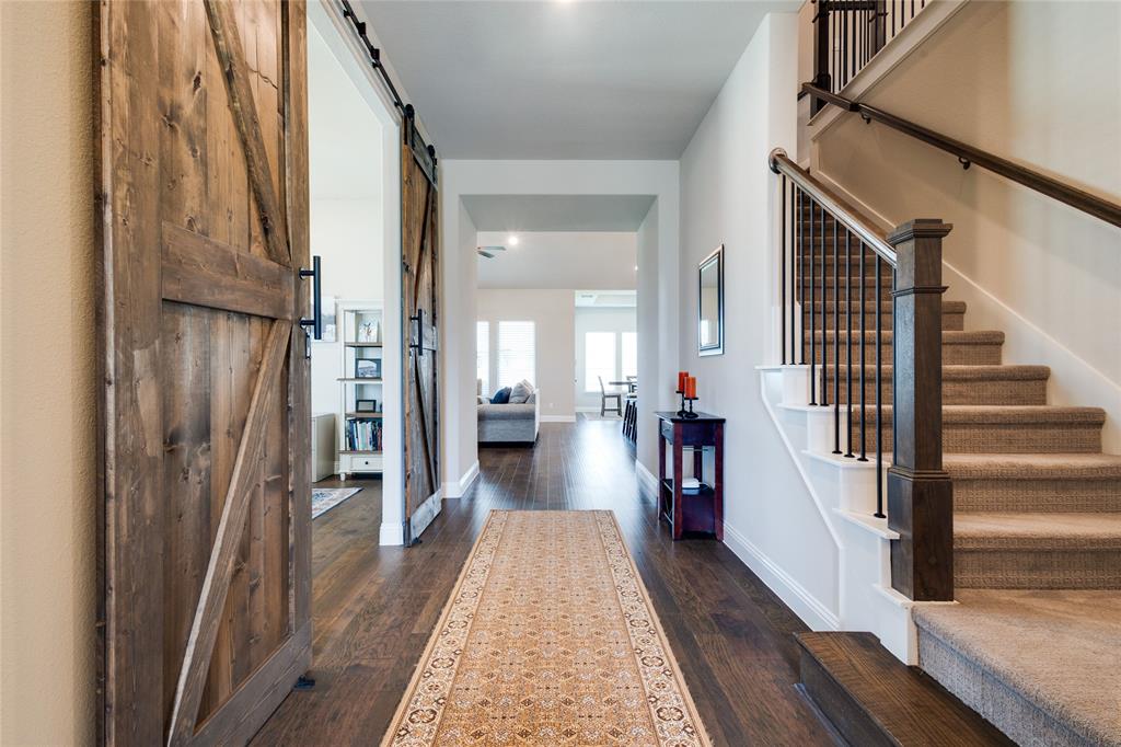 11112 Lacey Oak Ridge Flower Mound, TX 76226 - Photo 8 of 40 a view of a hallway with wooden floor and staircase