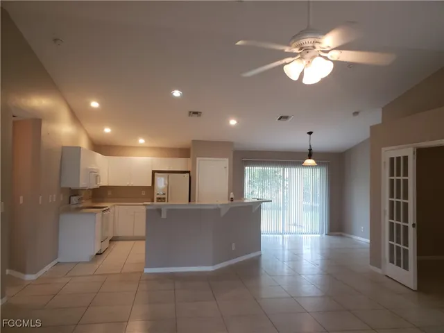 a view of a kitchen with a refrigerator and a microwave