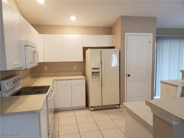 a kitchen with a stove a refrigerator and a sink