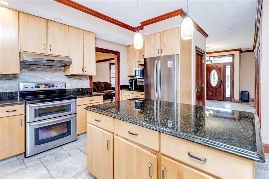3 Danielle Drive Danvers, MA 01923 - Photo 14 of 41 a kitchen with stainless steel appliances granite countertop a refrigerator a stove and a sink with cabinets