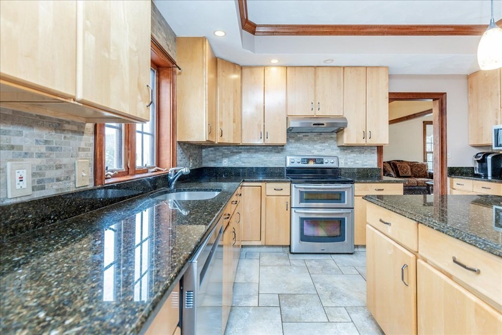 3 Danielle Drive Danvers, MA 01923 - Photo 15 of 41 a kitchen with stainless steel appliances granite countertop a stove and a sink