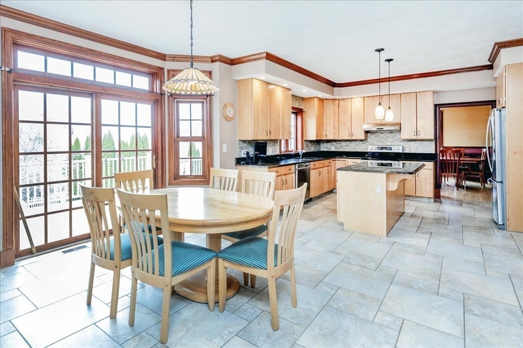3 Danielle Drive Danvers, MA 01923 - Photo 20 of 41 a kitchen with stainless steel appliances granite countertop a stove a sink a dining table and chairs with a large window