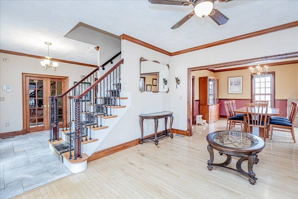 3 Danielle Drive Danvers, MA 01923 - Photo 9 of 41 a dining room with wooden floor a chandelier a wooden table and chairs