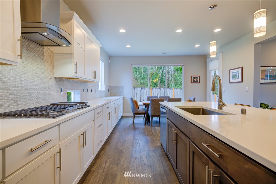 4792 Smithers Avenue South Renton, WA 98055 - Photo 11 of 37 a kitchen with stove a sink and cabinets