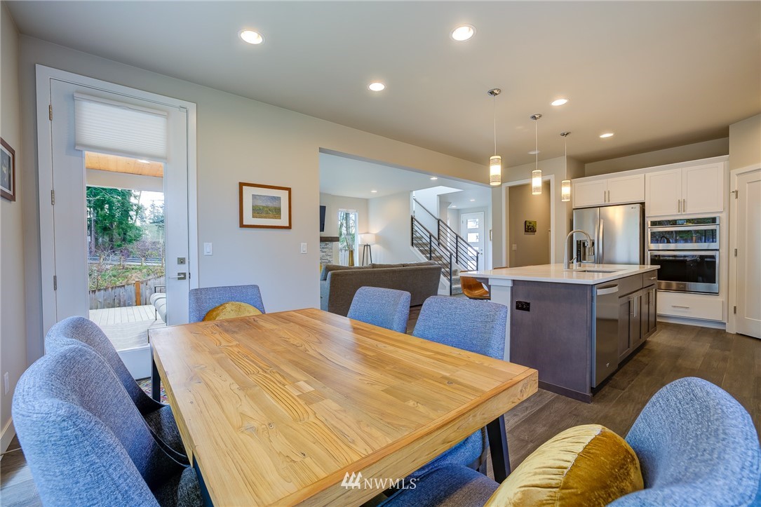 4792 Smithers Avenue South Renton, WA 98055 - Photo 14 of 37 a large kitchen with kitchen island a stove a sink a refrigerator dining table and chairs